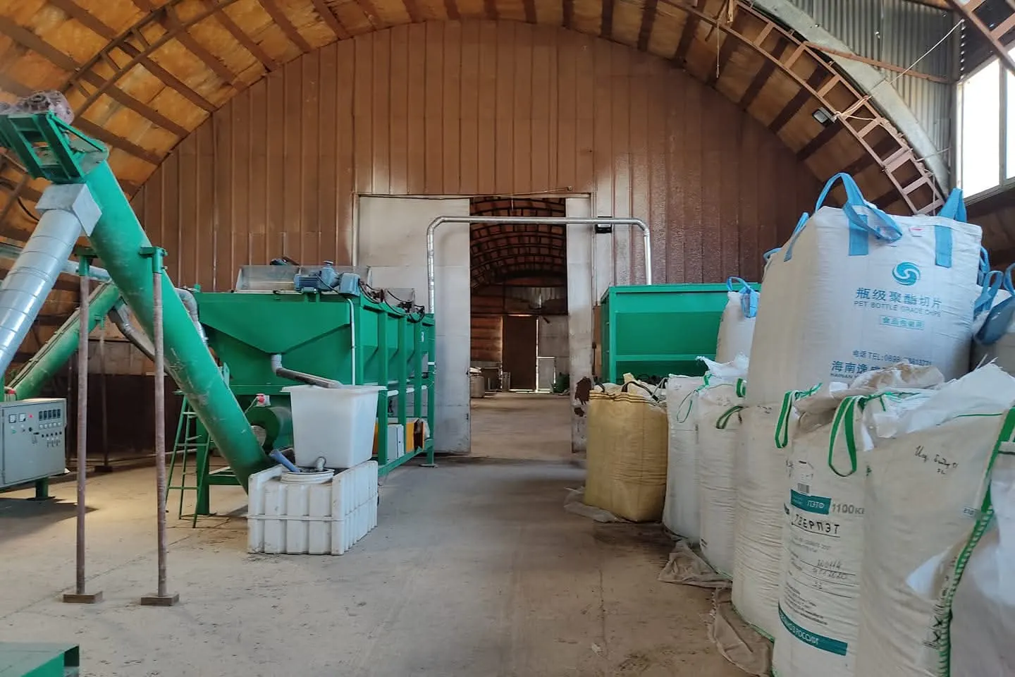 Recycling equipment and bulk bags of plastic inside the Necopolymer hangar