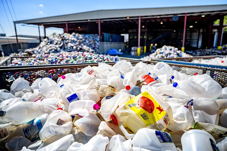 Used HDPE milk and detergent jugs at a recycling yard